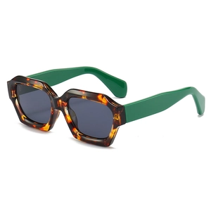 Modern hexagonal tortoise shell sunglasses with vibrant green temples in 45-degree view
