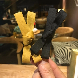Detail of vintage knotted wide headbands in yellow and black textured fabric