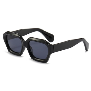 Modern irregular hexagonal sunglasses with thick black frames and dark grey lenses