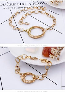Detail of gold chain bracelet with double interlocking rings and lobster clasp