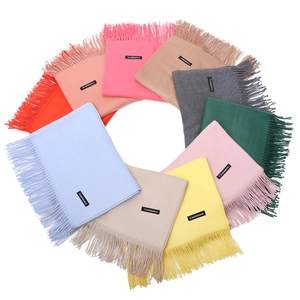 Solid cashmere-like tassel scarves for women in multiple vibrant colors and soft texture