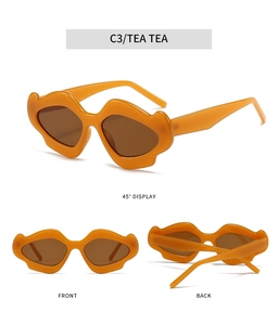 Detailed view of orange wavy irregular floral sunglasses with brown tinted lenses