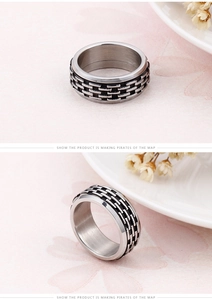 Detail of 304 stainless steel ring showing black woven texture and brushed metal finish