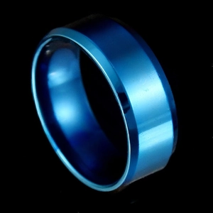Macro shot of polished blue electroplated stainless steel ring surface with smooth finish