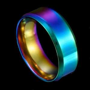 Macro side view of a vibrant rainbow plated stainless steel ring with polished finish