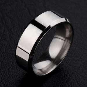 Macro view of polished stainless steel ring with smooth beveled edge on black leather
