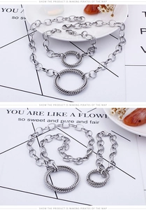 Macro detail of silver interlocking ring necklace and bracelet with twisted rope texture
