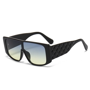 Modern oversized wrap sunglasses with gradient blue-yellow lenses and diamond textured temples