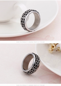 Detail of silver stainless steel ring featuring a black textured brick pattern inlay