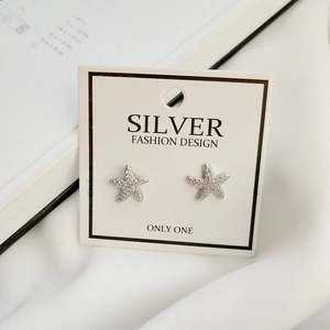 Macro shot of 925 sterling silver starfish stud earrings with sparkling cubic zirconia