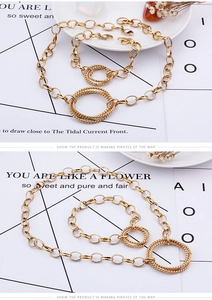 Detail view of gold titanium steel interlocking ring necklace and bracelet set