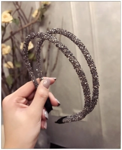 Detail of grey double-row rhinestone headband with protective anti-slip rubber ends