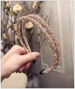 Detail of a double-layered rhinestone headband with sparkling crystals and anti-slip tips