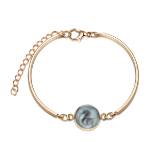 Detail of rose gold bangle featuring blue faux crystal center and adjustable lobster clasp