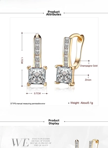 Detailed view of champagne gold zircon hoop earrings with square-cut center stones
