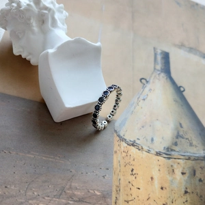 Detailed view of vintage S925 silver ring with a continuous black zircon cluster setting