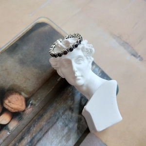 Detail of S925 sterling silver ring with black zircon set on a David plaster statue