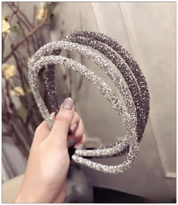Close-up of double-row rhinestone headbands in silver and dark grey crystal finishes