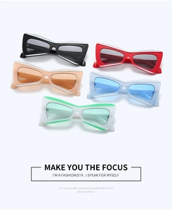 Flat lay of colorful thick cat-eye sunglasses in black red orange blue and green