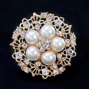 Golden flower brooch featuring elegant white pearls and sparkling crystals on black background