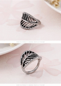 Detailed macro view of retro silver feather ring with sparkling rhinestones and openwork