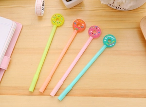 Close-up of four colorful donut-shaped gel pens on a desktop for stationery lovers
