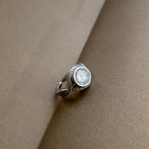 Detailed macro view of 925 silver ring featuring a large brilliant round-cut center stone