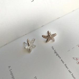Close-up of S925 sterling silver starfish stud earrings with micro-pave white zircon stones