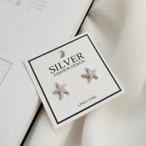 Macro shot of 925 sterling silver starfish stud earrings with micro-set cubic zirconia