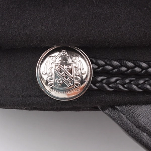 Classic black wool navy hat with a leather brim and silver crest button detail