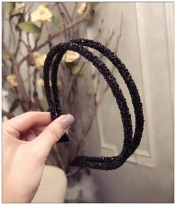 Close-up of double-layer black headband with sparkling rhinestones and non-slip fabric ends