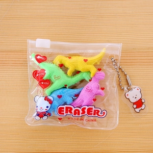 Detail of four colorful dinosaur-shaped erasers in a clear PVC pouch with a cute bear charm