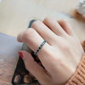 Macro shot of S925 silver ring featuring vintage crown-set black cubic zirconia stones