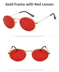Detail of vintage oval sunglasses featuring gold metal frames and vibrant red lenses