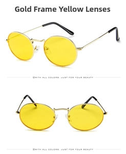 Detail view of retro oval sunglasses with gold metal frame and transparent yellow lenses