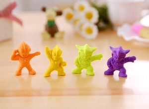 Macro shot of colorful cartoon superhero mini erasers in orange, yellow, green, and purple