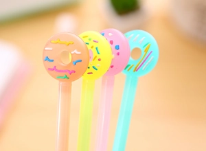 Detail of colorful donut-shaped pen toppers in orange, yellow, pink and blue