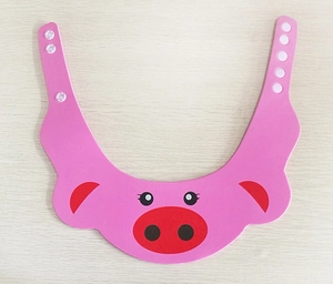 Detailed view of pink cartoon pig baby shower cap with adjustable plastic buckles