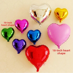 Detail view of 10 and 18 inch heart shaped foil balloons in various metallic colors