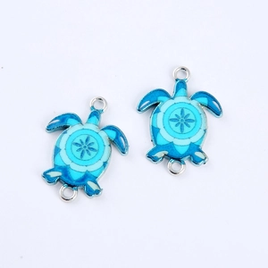 Detailed macro view of blue enamel sea turtle double charms for DIY jewelry making