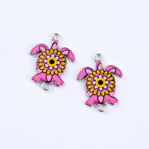 Pink and yellow turtle double-connector charms with floral enamel patterns
