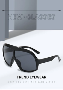 Front view of oversized black shield sunglasses featuring deep grey tinted lenses