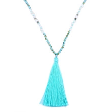 Detail of bohemian long tassel necklace with light blue beads and soft silk fringe