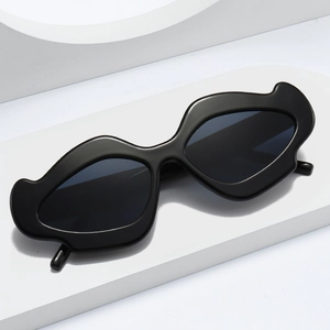 Irregular wavy black flower sunglasses with thick frames and dark gray lenses