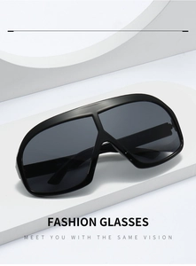 Detail view of fashion oversized shield sunglasses with black frames on geometric props