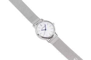 Detailed macro view of silver mesh band and white dial with blue hands quartz watch