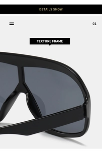 Detail shot of oversized rimless sunglasses featuring a glossy black texture frame