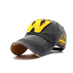 Detail of vintage washed dark gray cotton cap with yellow W patch and side embroidery