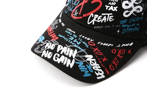 Détail d'une casquette de baseball noire style urbain avec graffiti No Pain No Gain