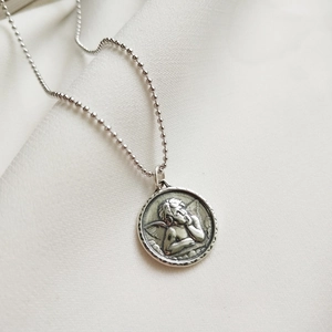 Retro 925 sterling silver guardian angel relief pendant necklace with bead chain on white fabric